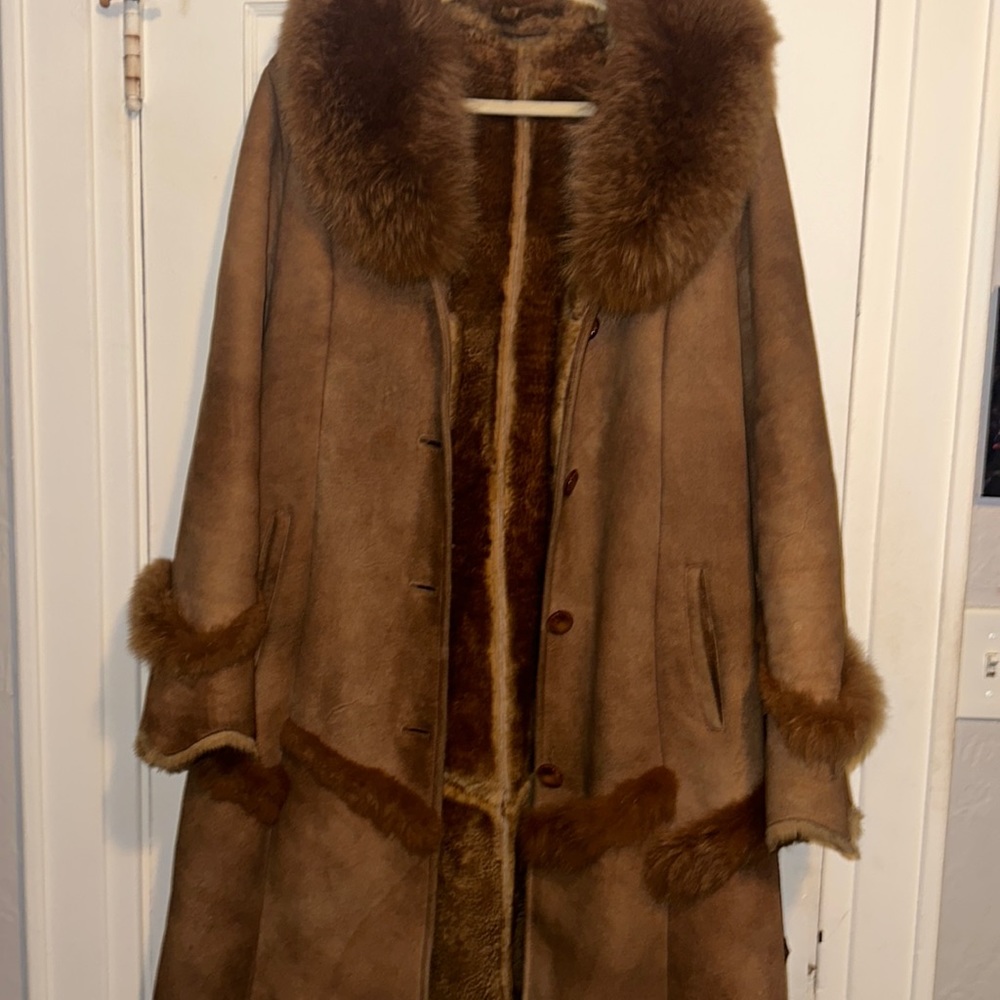 Woman’s brown fur and suede coat.